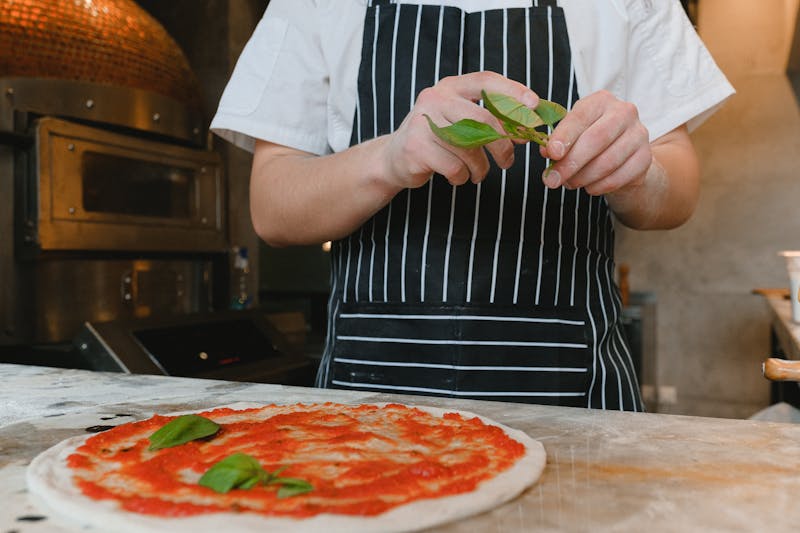 Giordanos team members crafting our signature giordanos pizza with fresh ingredients